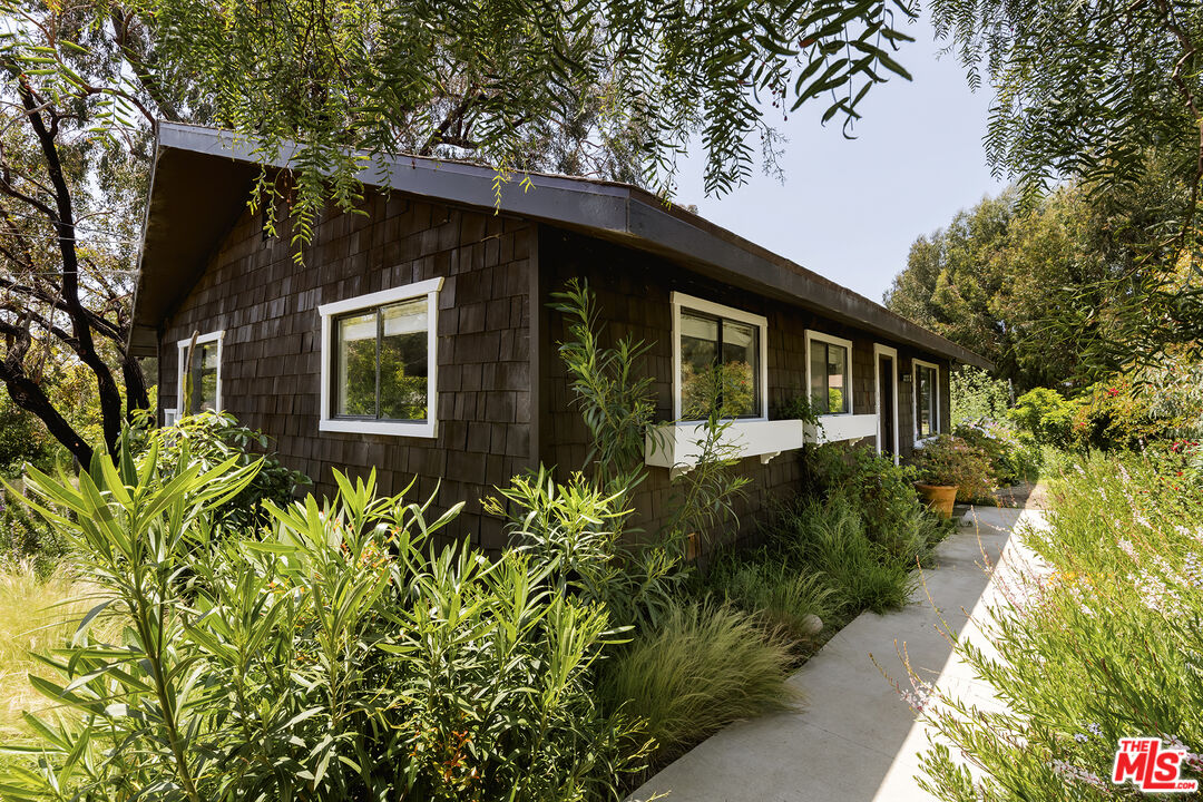 6551 Zumirez Drive Malibu, CA 90265 - Photo 2 of 36 a front view of a house with a yard