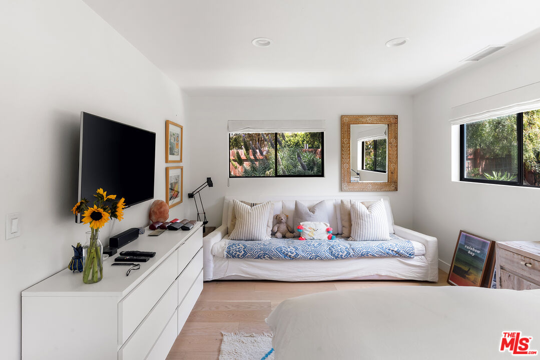 6551 Zumirez Drive Malibu, CA 90265 - Photo 22 of 36 a living room with furniture and a flat screen tv