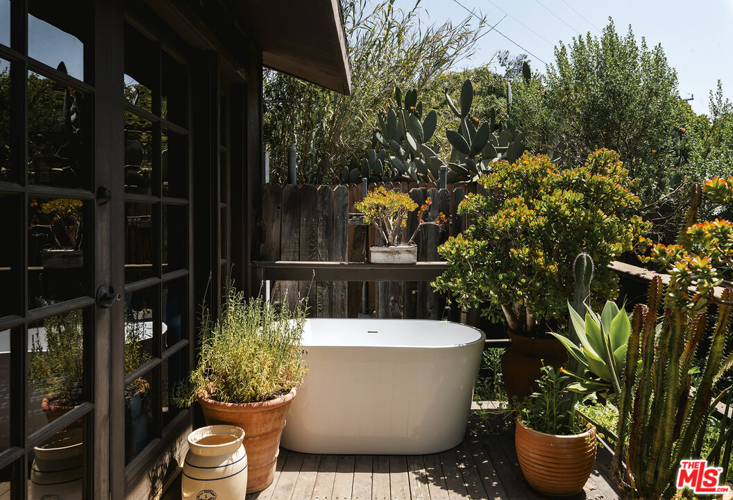 6551 Zumirez Drive Malibu, CA 90265 - Photo 27 of 36 a view of a bathtub in patio with potted plants