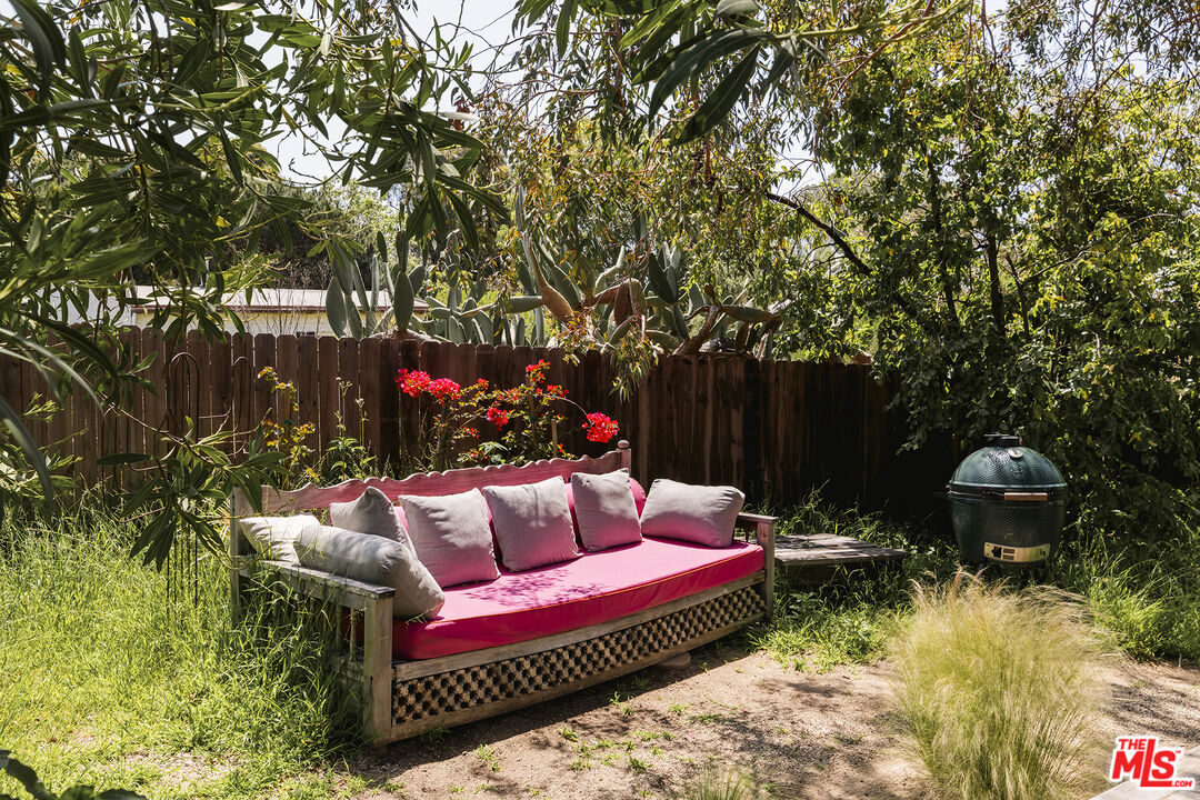 6551 Zumirez Drive Malibu, CA 90265 - Photo 30 of 36 a view of a wooden chairs and bench in the backyard