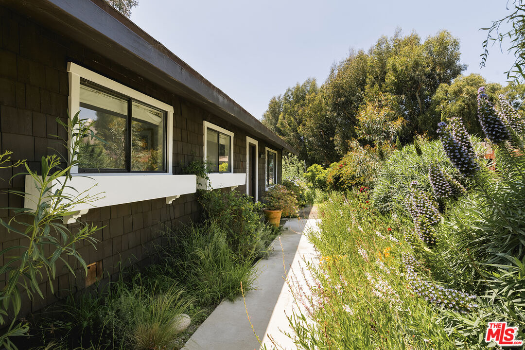 6551 Zumirez Drive Malibu, CA 90265 - Photo 3 of 36 a view of house with garden