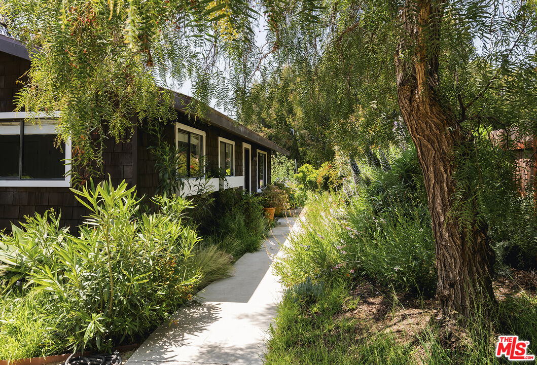 6551 Zumirez Drive Malibu, CA 90265 - Photo 4 of 36 a view of a garden with large trees