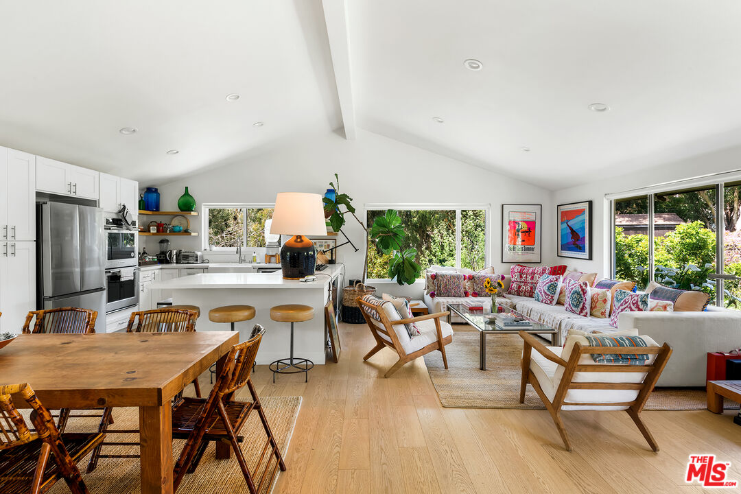 6551 Zumirez Drive Malibu, CA 90265 - Photo 9 of 36 a living room with dining room and wooden floor