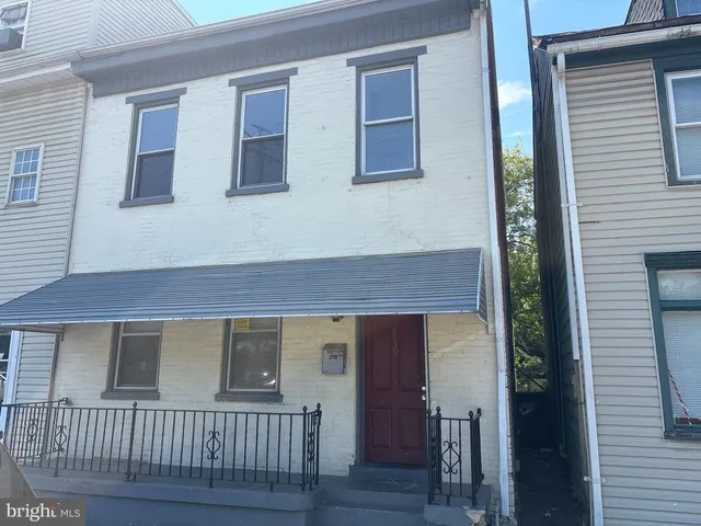 a view of a house with wooden deck