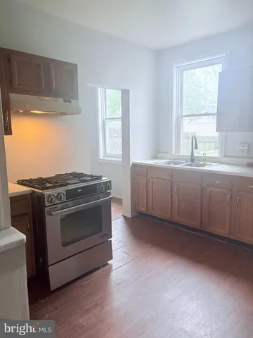 a kitchen with stainless steel appliances granite countertop a stove and a sink