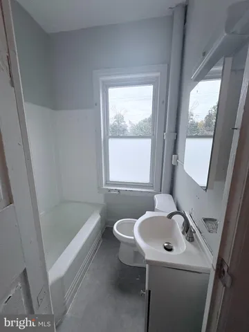 a bathroom with a sink a mirror and a bathtub