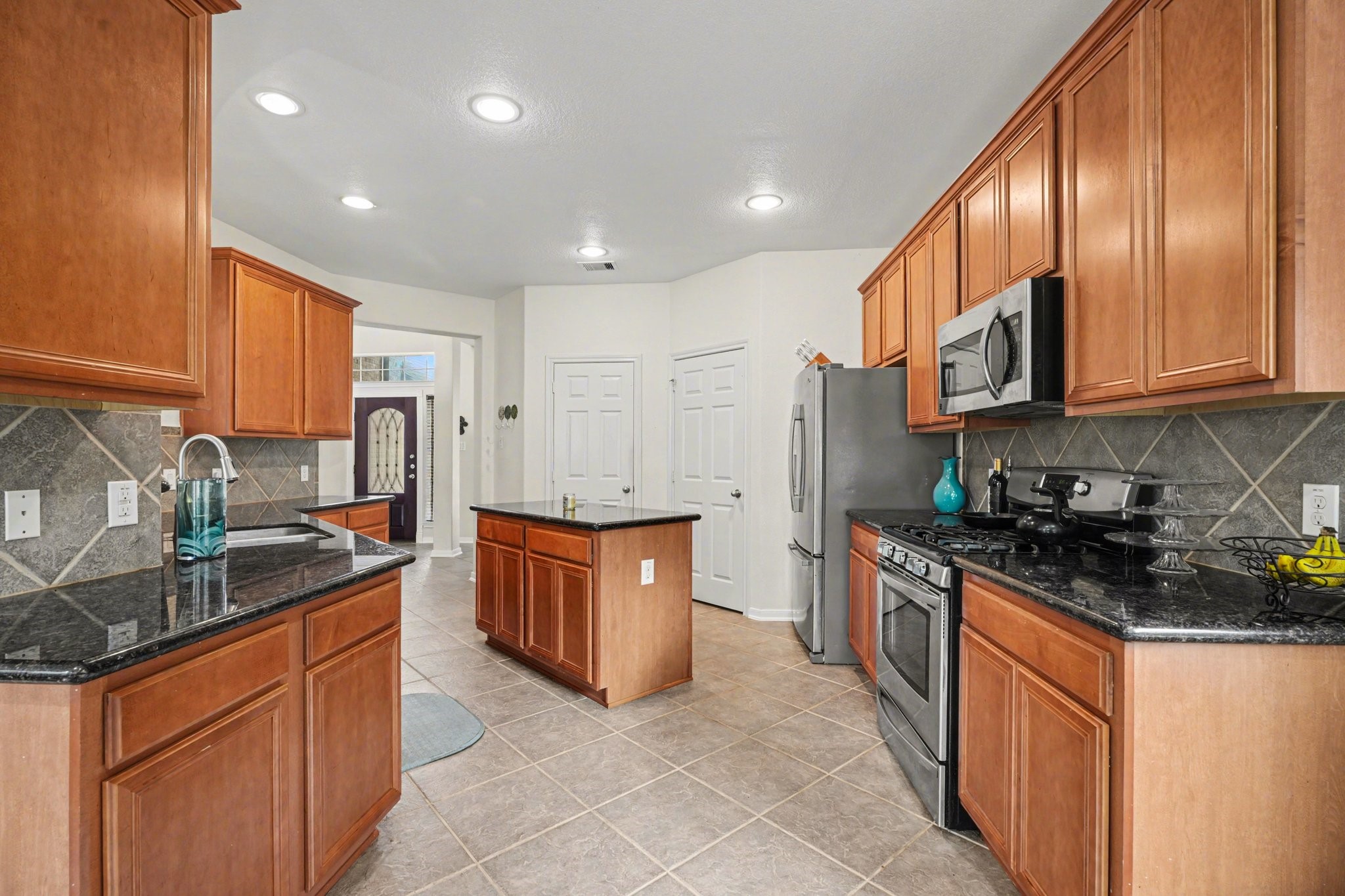 806 Dawn Ridge Way Seabrook, TX 77586 - Photo 12 of 39 a large kitchen with stainless steel appliances granite countertop a stove a sink dishwasher and a refrigerator