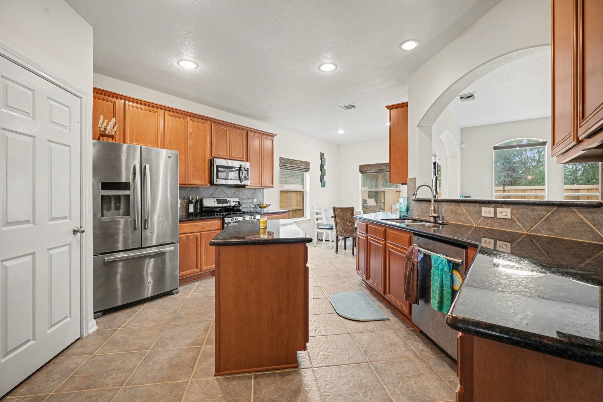 806 Dawn Ridge Way Seabrook, TX 77586 - Photo 14 of 39 a kitchen with stainless steel appliances granite countertop a refrigerator a sink a stove top oven and a refrigerator