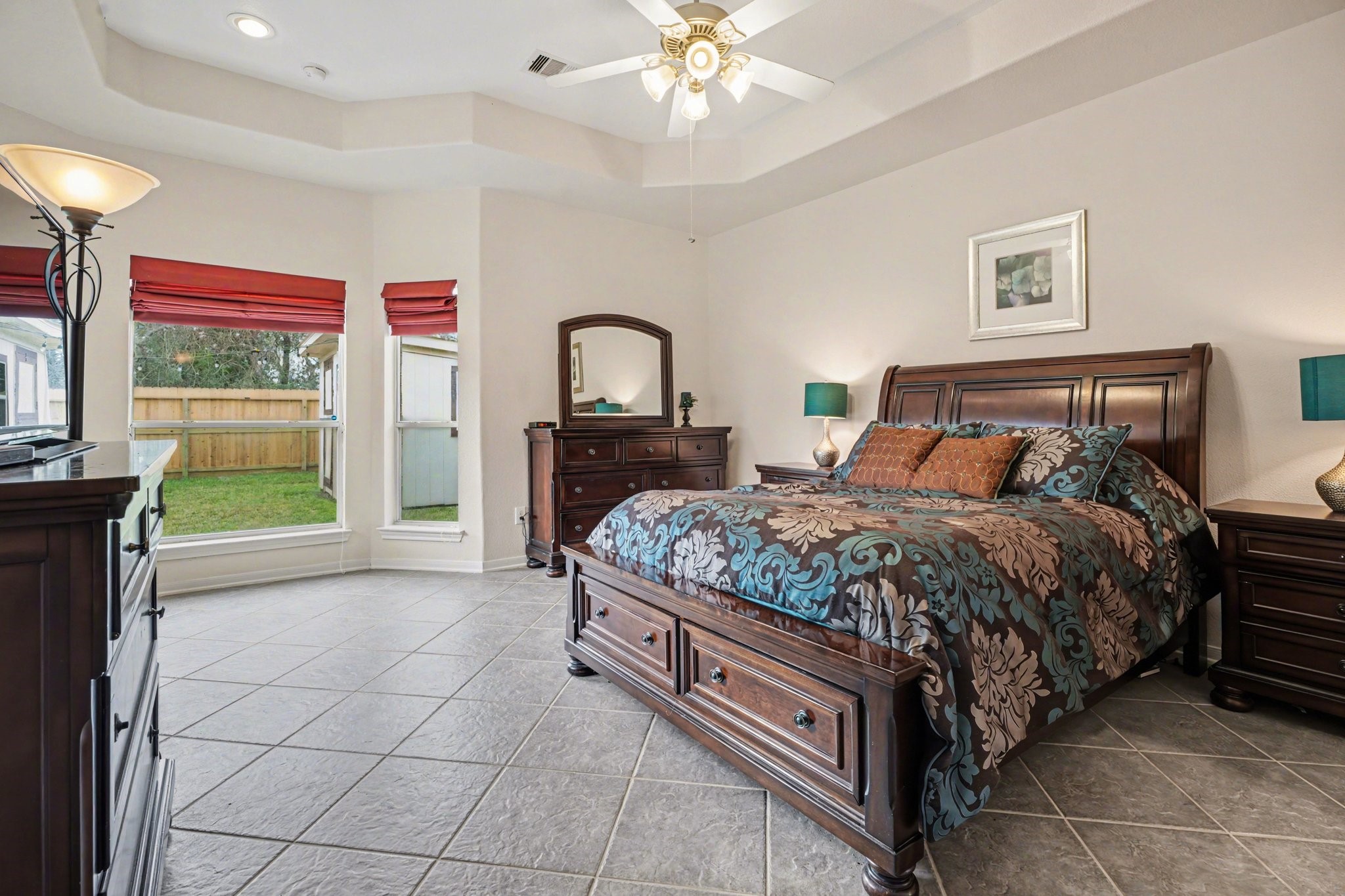 806 Dawn Ridge Way Seabrook, TX 77586 - Photo 15 of 39 a bedroom with a bed and a chandelier