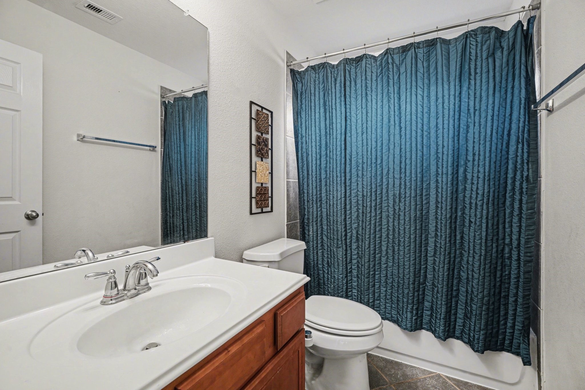 806 Dawn Ridge Way Seabrook, TX 77586 - Photo 26 of 39 a bathroom with a sink a toilet and shower curtain