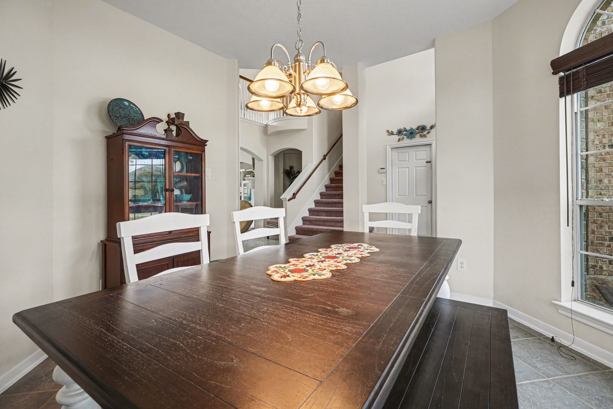 806 Dawn Ridge Way Seabrook, TX 77586 - Photo 6 of 39 a dining room with wooden floor a chandelier a wooden table and chairs