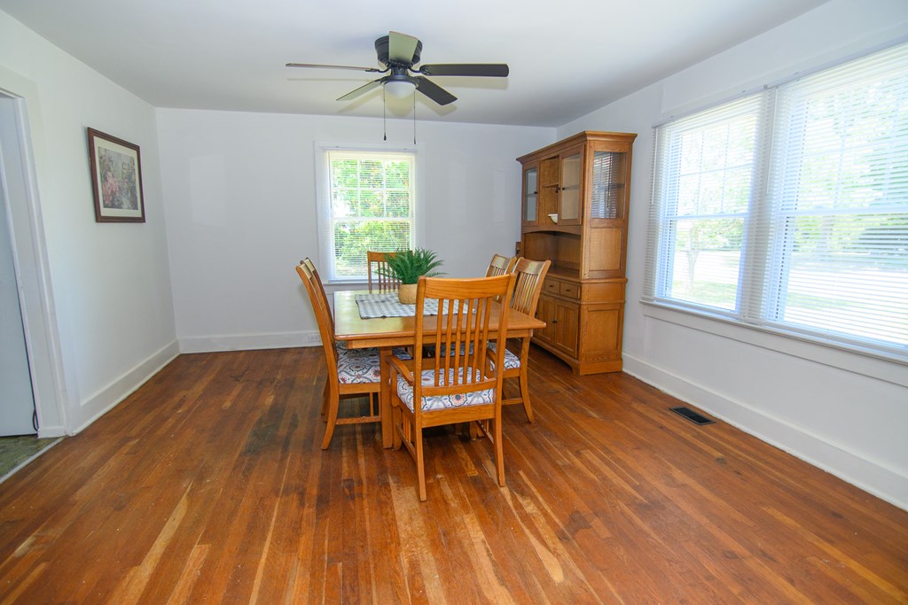 24432 Maxwell Street Parksley, VA 23421 - Photo 12 of 39 a view of a dining room with furniture window and wooden floor