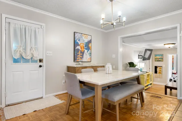 a view of a dining room with furniture and chandelier