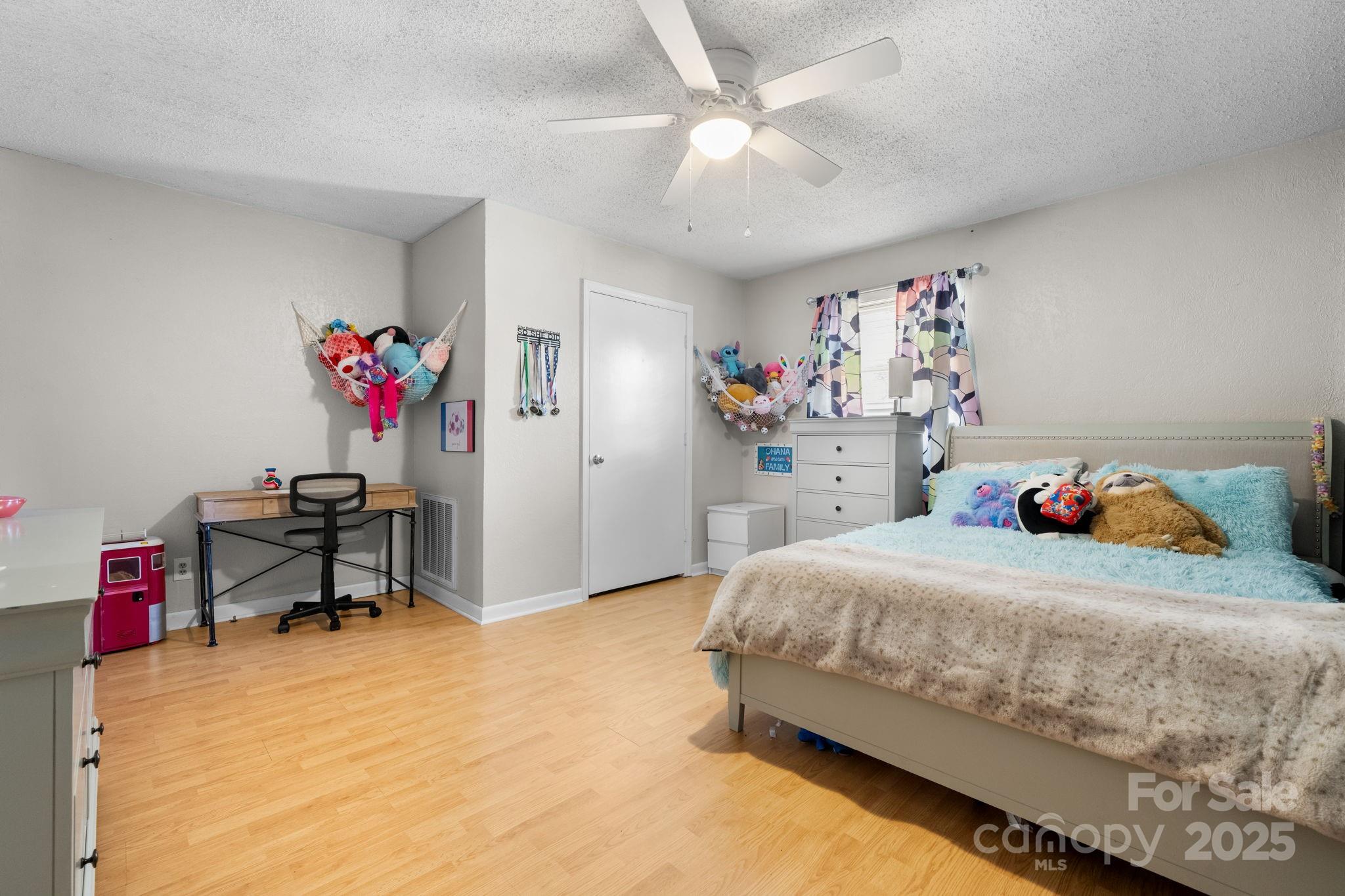 1553 Castell Lane Hickory, NC 28601 - Photo 22 of 27 a bedroom with a bed and a chandelier