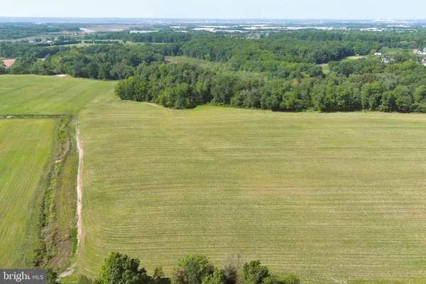 a view of a field with an ocean view