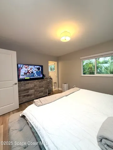 a spacious bedroom with a bed and window