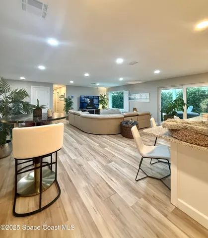 a living room with furniture a dining table and kitchen view