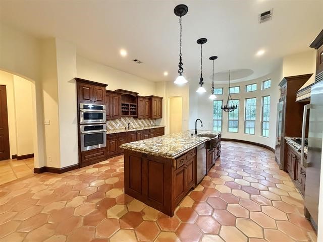 12410 Keith Road Beaumont, TX 77713 - Photo 7 of 45 a kitchen with stainless steel appliances granite countertop a stove oven and a refrigerator