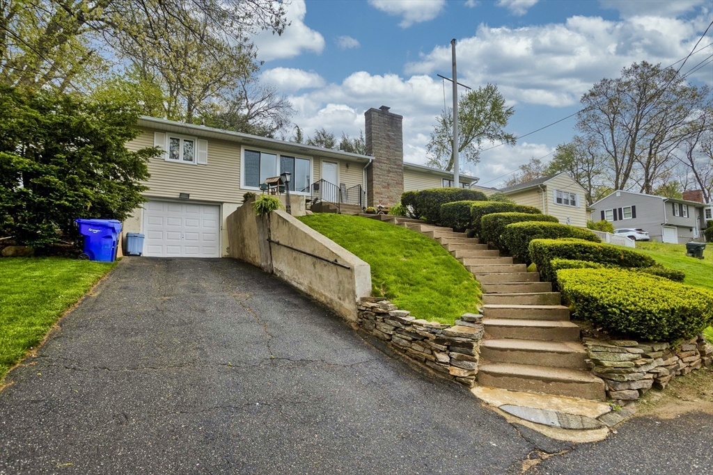 87 Benz Street Springfield, MA 01118 - Photo 3 of 30 a front view of a house with a yard and garage