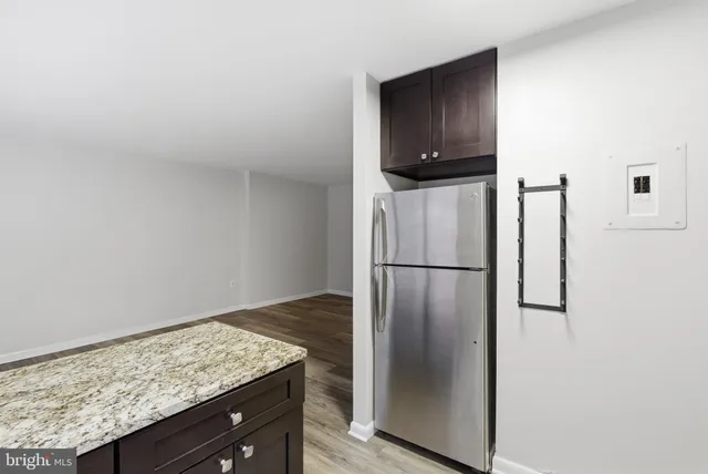 a kitchen with a refrigerator and countertop
