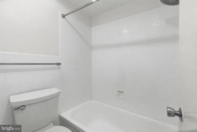 a bathroom with a toilet and bathtub