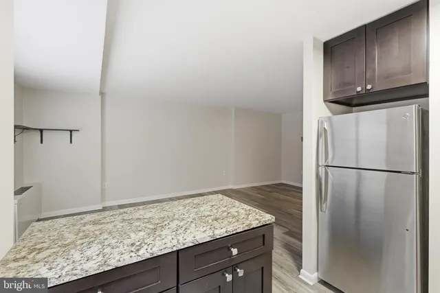 a kitchen with a refrigerator and cabinets