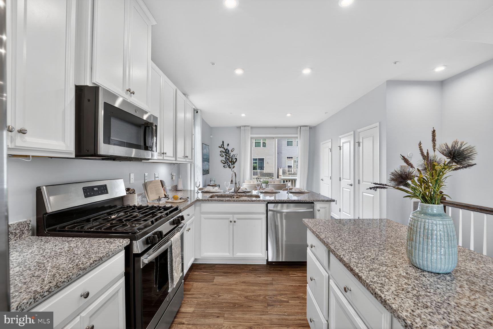 3111 Potters Hill Road Hanover, MD 21076 - Photo 7 of 40 a kitchen with stainless steel appliances granite countertop a sink stove and cabinets