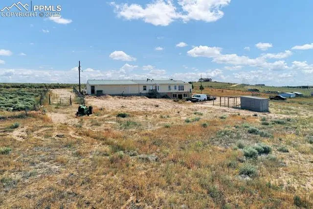 a living room with furniture a window and wall painting