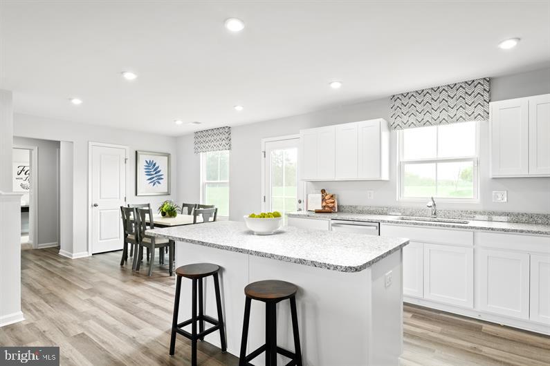 9216 Cooks Point Court, Unit 34 Lanham, MD 20706 - Photo 4 of 17 a kitchen with a table chairs sink and cabinets