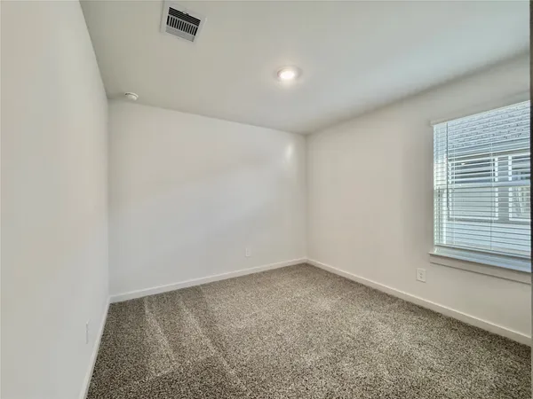 an empty room with a empty space and windows