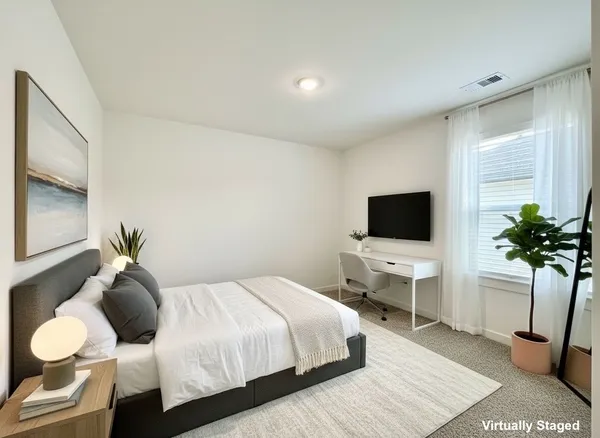 a bedroom with a bed and flat screen tv