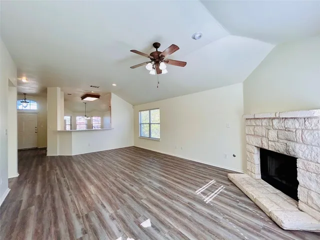wooden floor in an empty room with a fireplace