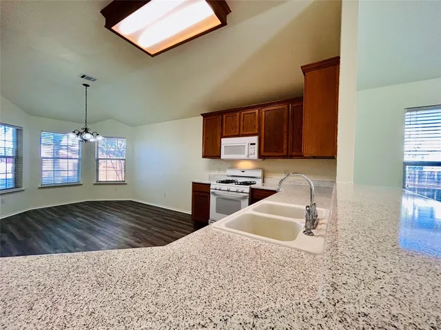 a kitchen with a stove a sink and a refrigerator