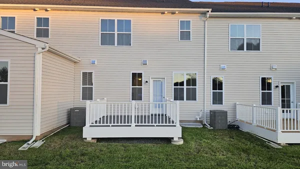 a view of a house with a yard and deck