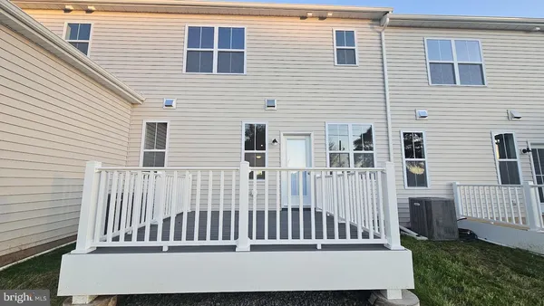 a kitchen with kitchen island granite countertop a sink refrigerator and cabinets