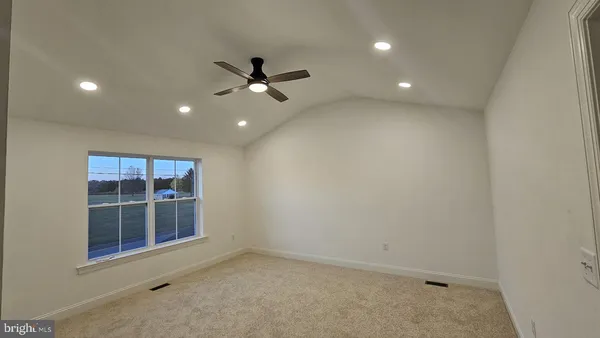 an empty room with closet and a bathroom