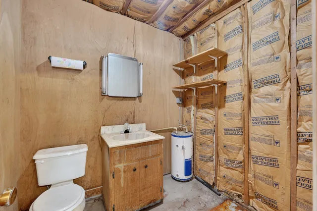a bathroom with a toilet sink and shower