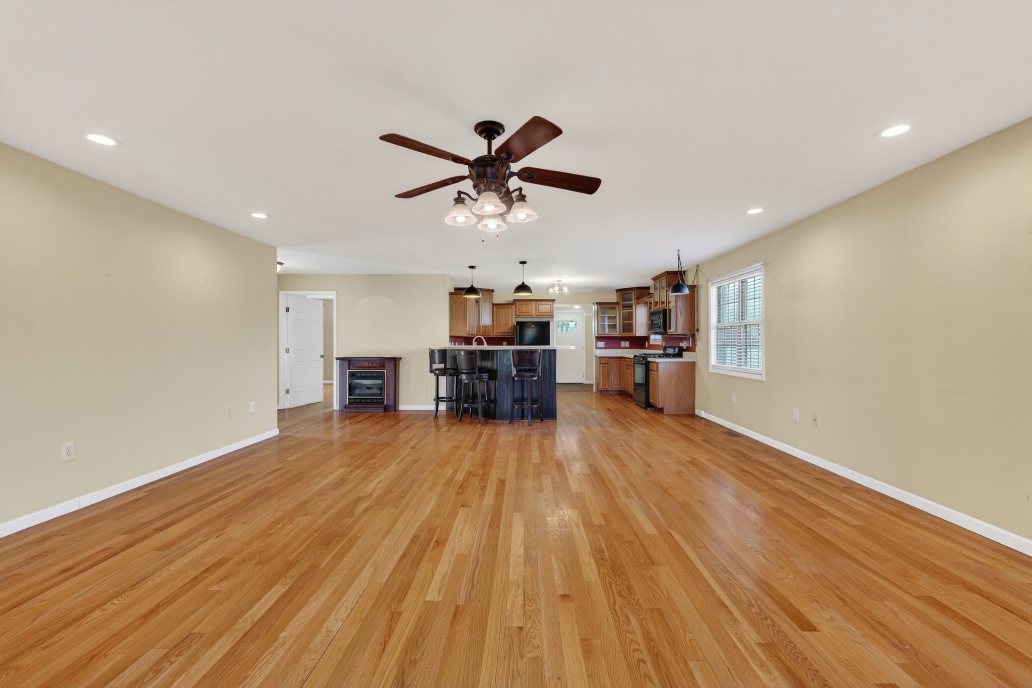 44 Old Camargo Road Fayetteville, TN 37334 - Photo 5 of 38 a view of a room with wooden floor a ceiling fan and kitchen space