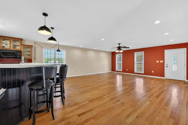 a view of a dining room with furniture and wooden floor