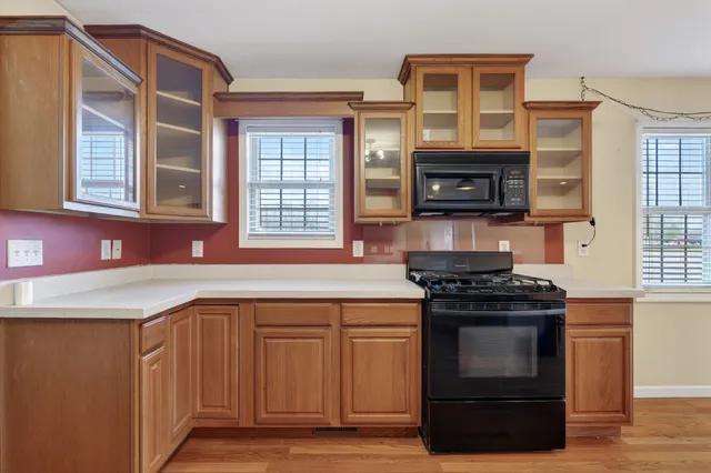 a kitchen with stainless steel appliances granite countertop a stove and a microwave