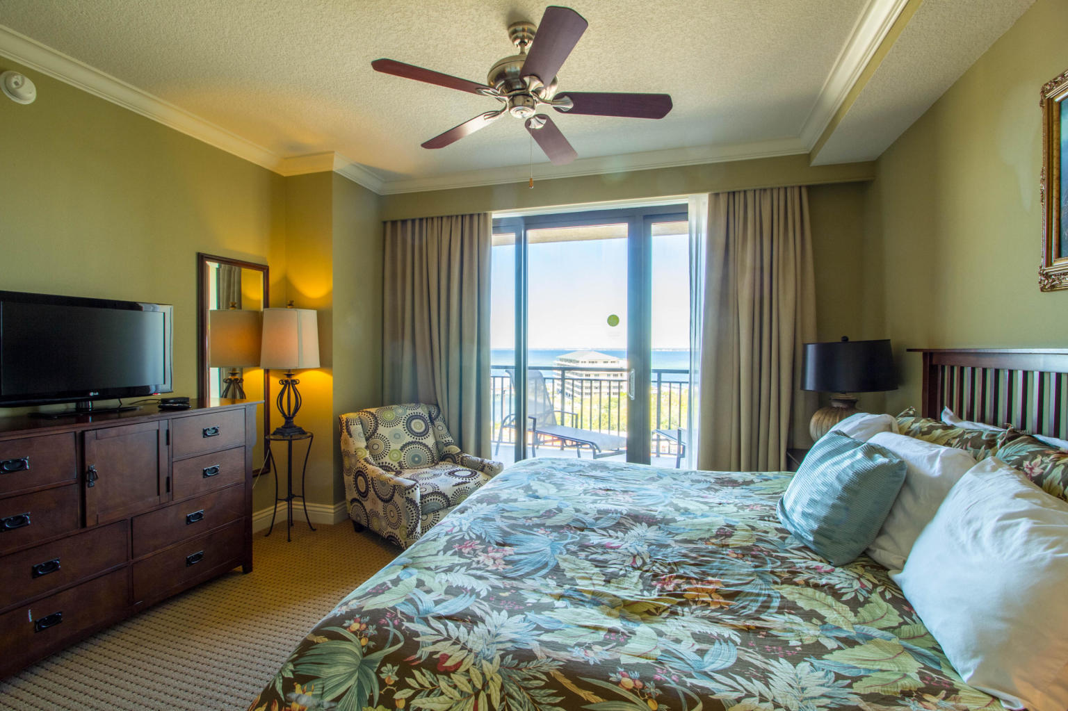 10 Harbor Boulevard, Unit W528 Destin, FL 32541 - Photo 6 of 25 a bedroom with a bed and a flat screen tv on dresser