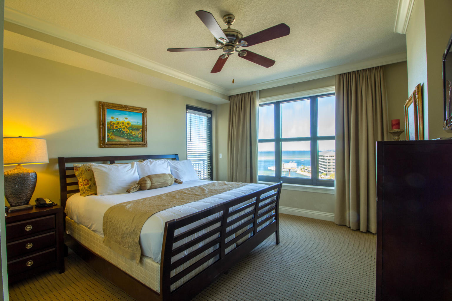 10 Harbor Boulevard, Unit W528 Destin, FL 32541 - Photo 10 of 25 a bed room with a bed and a ceiling fan