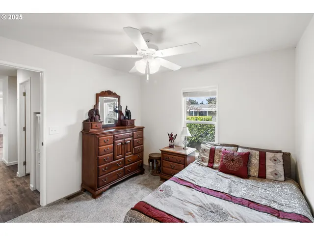 a bedroom with a bed and a mirror