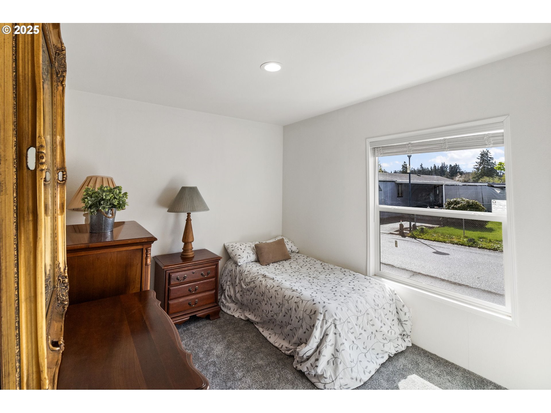 5335 Main Street, Unit 187 Springfield, OR 97478 - Photo 24 of 39 a bedroom with a bed and a mirror