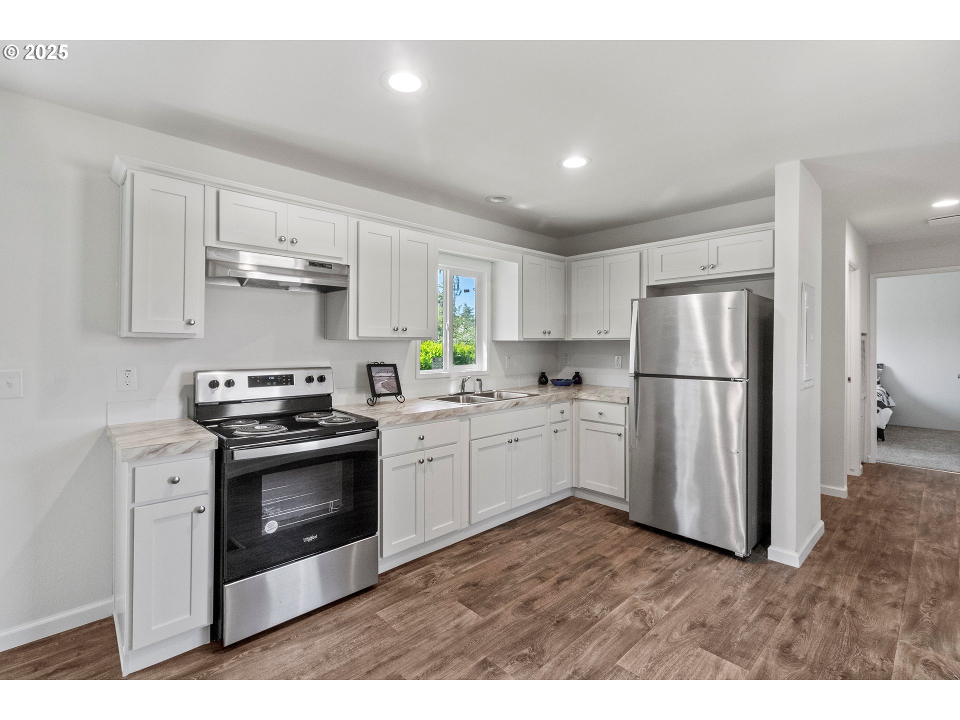 5335 Main Street, Unit 187 Springfield, OR 97478 - Photo 4 of 39 a kitchen with stainless steel appliances granite countertop a refrigerator stove a sink and dishwasher