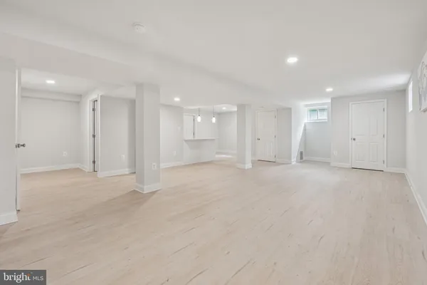 a view of an empty room with a kitchen