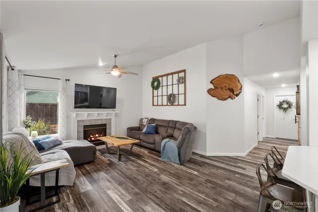 a living room with furniture flat screen tv and a fireplace