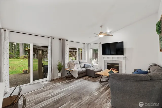 a living room with furniture a fireplace and a flat screen tv