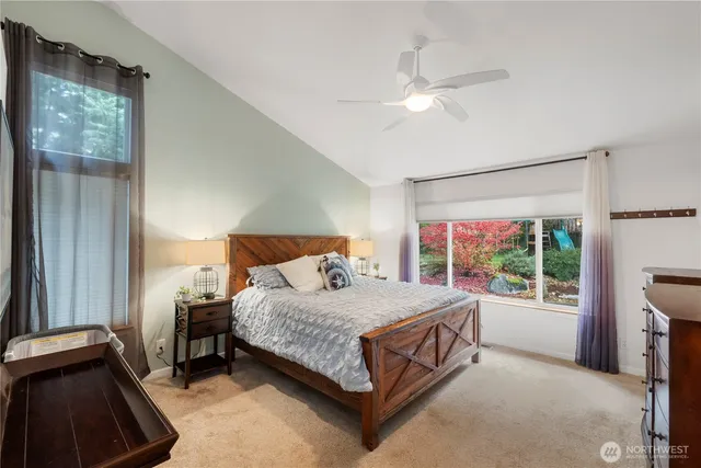 a bedroom with a bed table and a window