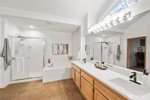 a spacious bathroom with a double vanity sink mirror and double